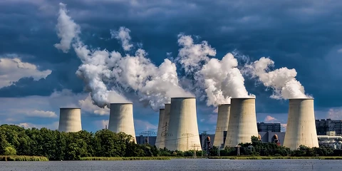 Numerous large chimneys emitting flue gas