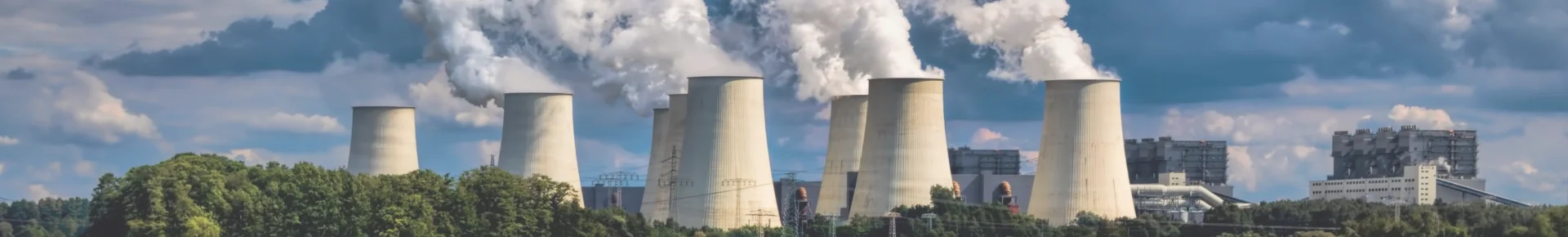 Numerous large chimneys emitting flue gas