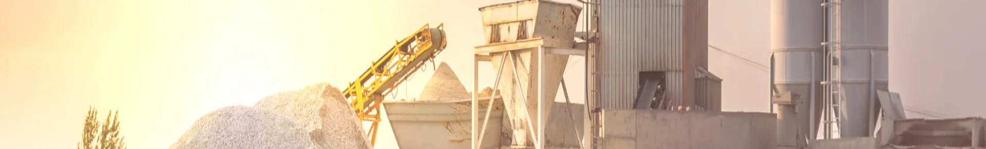 A pile of lime and sand stacked in front of dust collection equipment