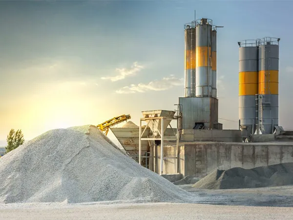 A pile of lime and sand stacked in front of dust collection equipment