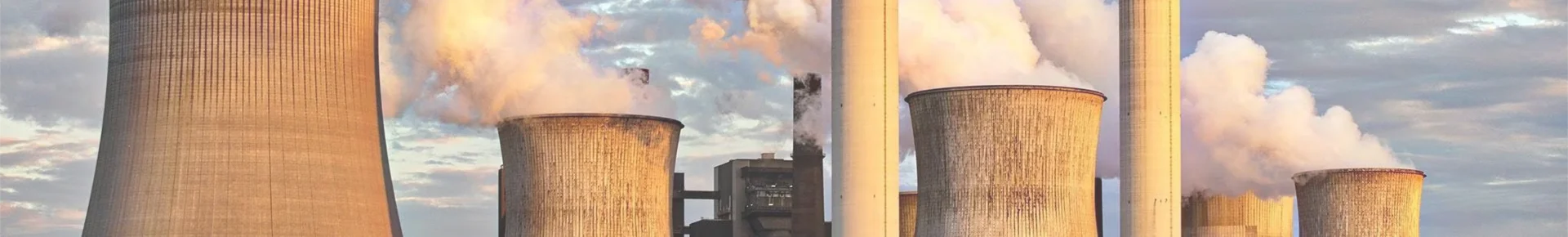 Numerous chimneys emitting flue gas in a coal-fired power plant