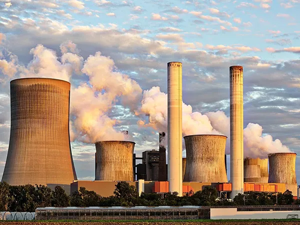 Numerous chimneys emitting flue gas in a coal-fired power plant