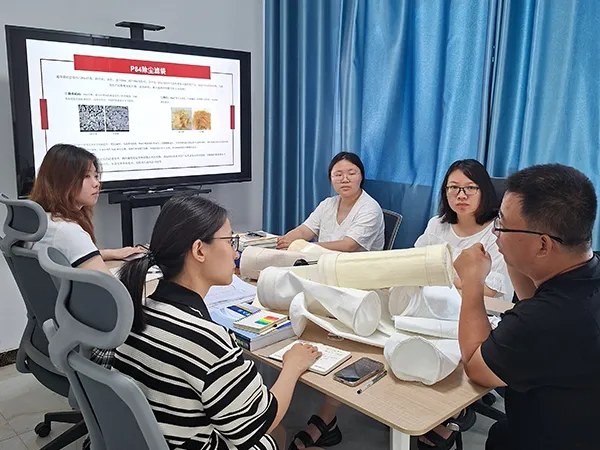 PureFlow employees are listening to the training on dust collector filter bag knowledge.