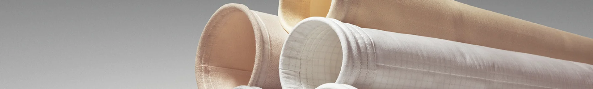 Several types of dust collector filter bags stacked together