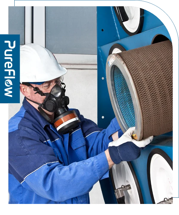 A worker is replacing the duct collector filter cartridge.