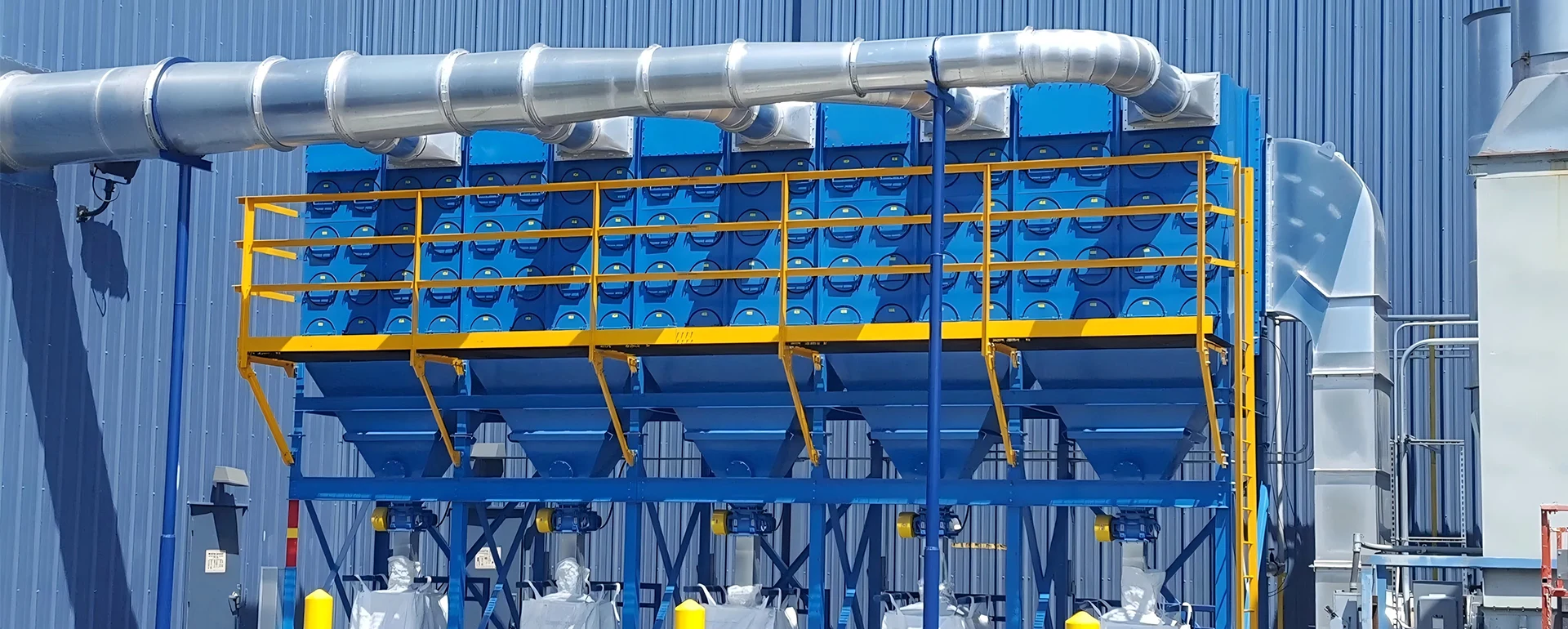 Multiple blue dust collectors placed on the ground