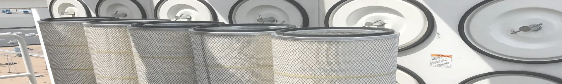 Multiple dust collector cartridge filters placed in front of a cartridge dust collector