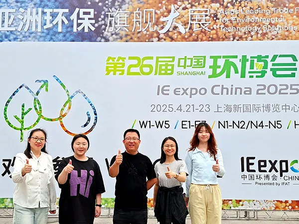 PureFlow employees posing for a group photo in front of the promotional banner