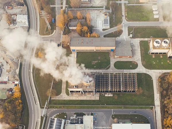 Many cooling towers are emitting white plumes.