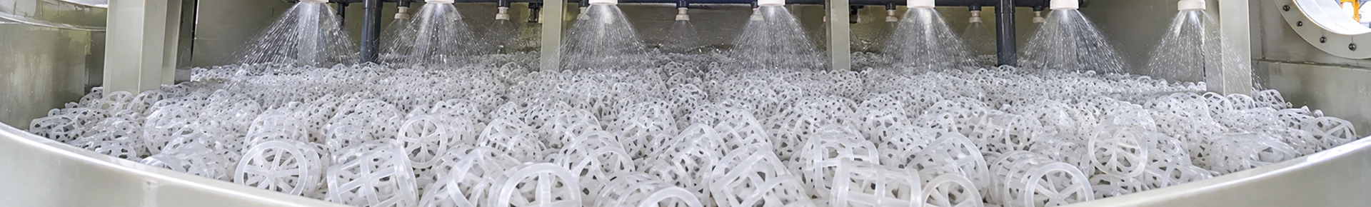 Many spray nozzles are spraying over the random packing.