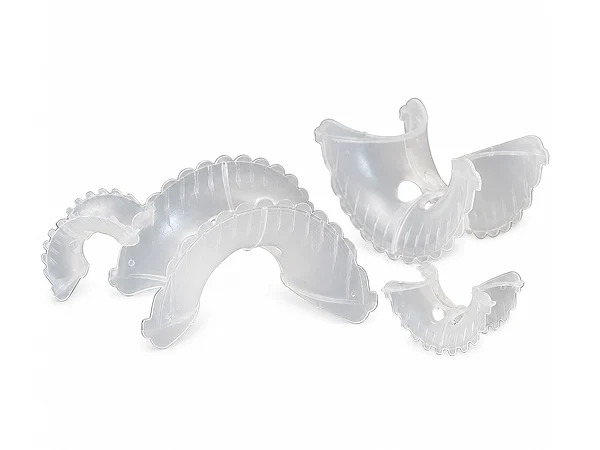 Several Super Intalox saddle rings of different sizes arranged together.
