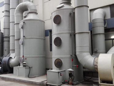 Multiple scrubber towers installed on pipelines.